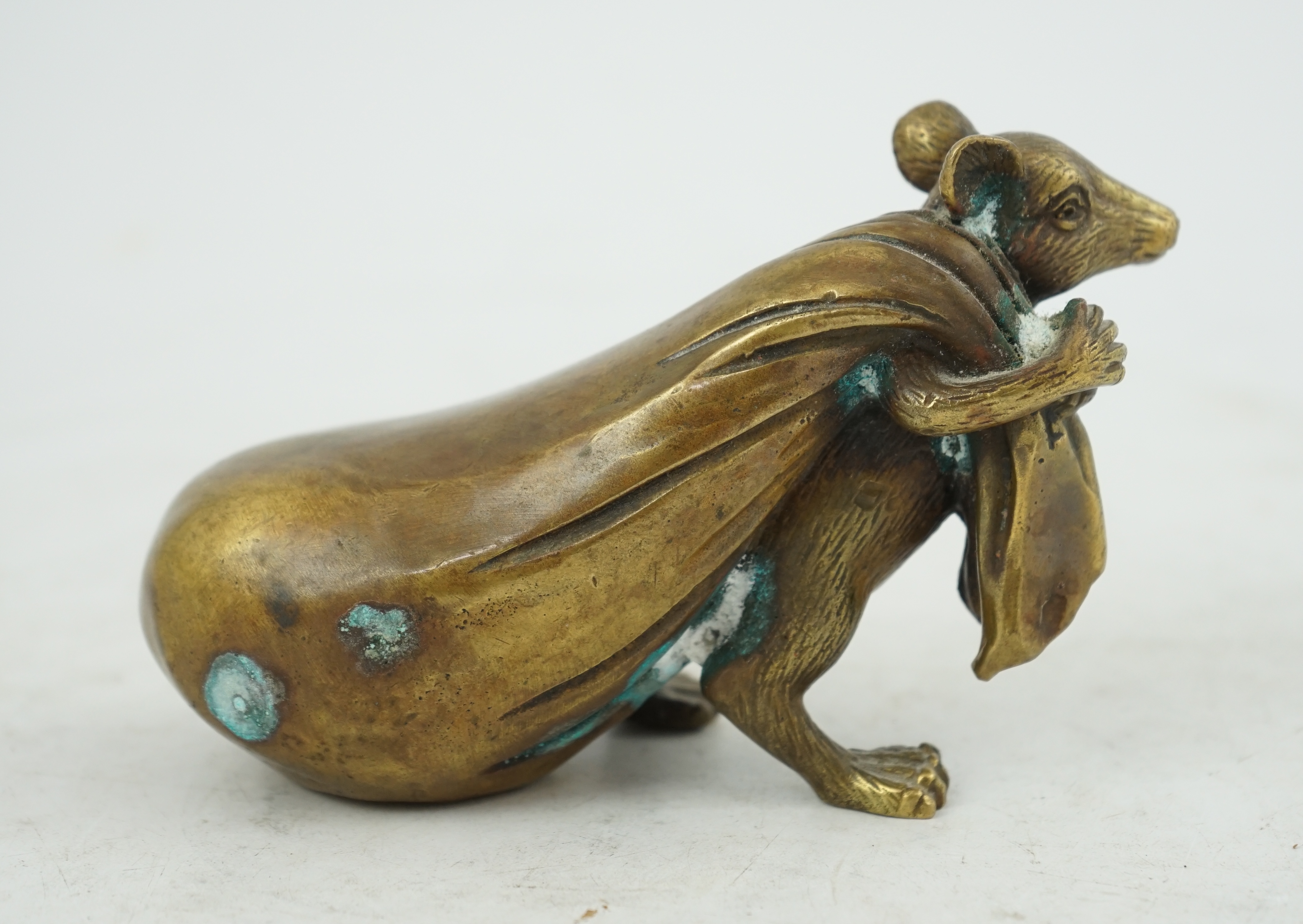 A Chinese bronze rat carrying a sack, signed in casting, 14cm long. Condition - fair